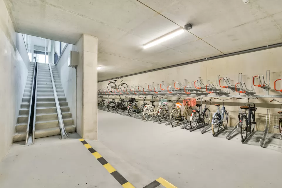 Bike parking in underground area with ramp for taking bikes upstairs.